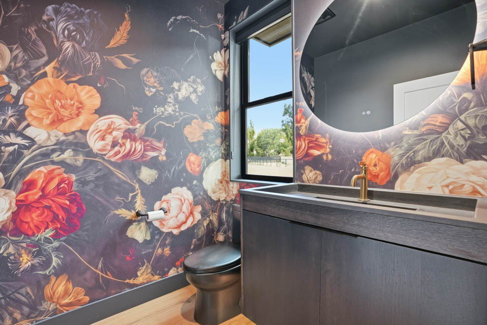 Dramatic powder room with floral wallpaper