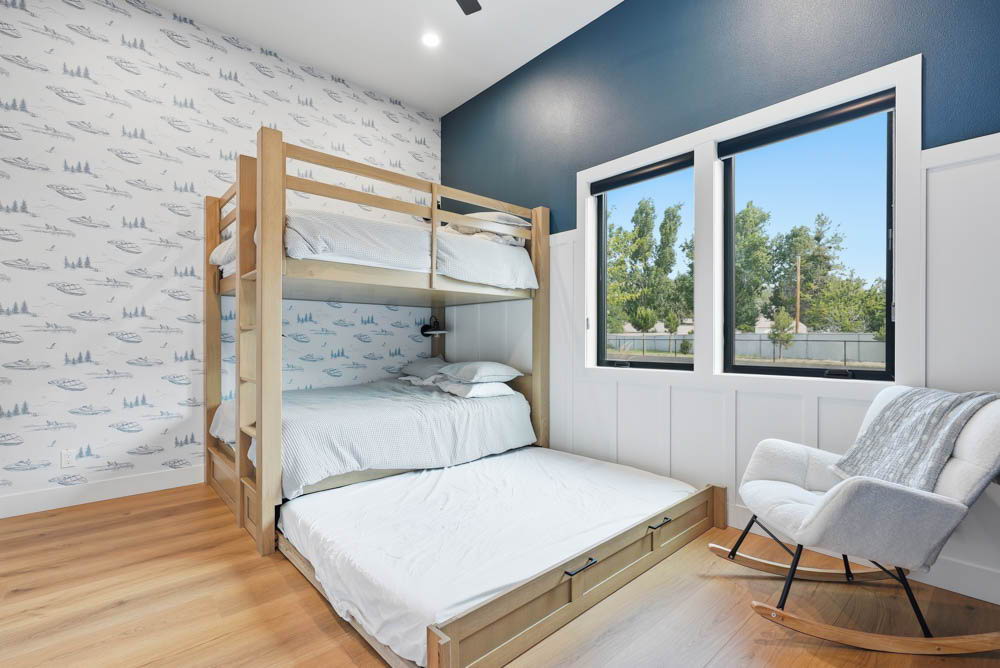 Navy bunk room with boat wallpaper